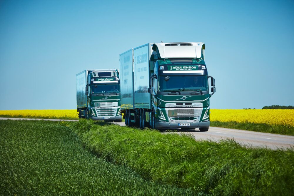 Two green and white trucks.